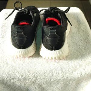 "Women's athletic shoe in black w red and yellow trim. Size  "